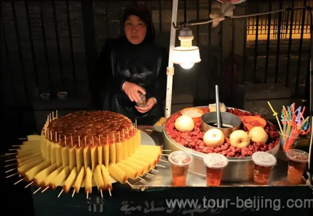 A vendor selling cakes and date drinks