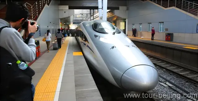 The highspeed train is sleek, thin and long with its head looking like a plane.