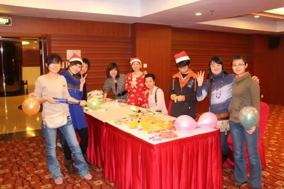 At registration table, people are busy preparing for the party, blowing the balloons, get ready the gifts (plush rabbit toys)...