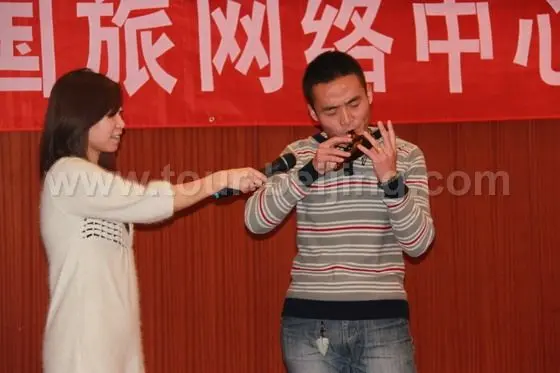 Mr. Luo is playing the ocarina - an ancient musical instrument.
