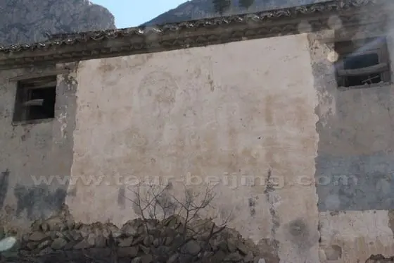 A Mao's wall picture and and slogan still visible