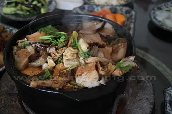 A casserole contains fresh, frozen and deep fried tofu mixed with meat, bacon and Chinese cabbage.
