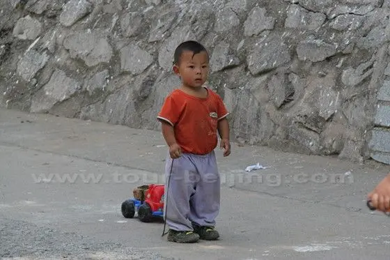 A farm boy with a toy.