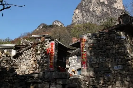 A stone house with a beautiful backdrop.