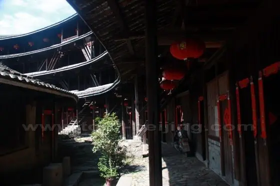 Between the four storeys outer ring and the one storey building in the second ring.