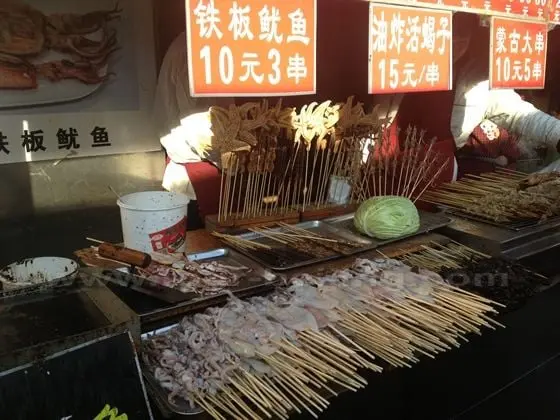 Fried squids ans fried live scorpions on sticks