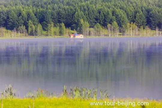 The surface of the quiet lake resembles a huge mirror with multi-color reflections