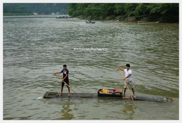 Fruit vendors paddle rickety bamboo rafts