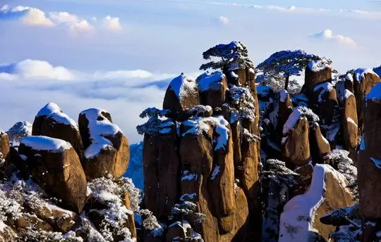 Fantastically shaped granite peaks toppled by white snow