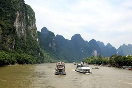 Passing by the steep cliffs and idyllic villages while cruising Li River