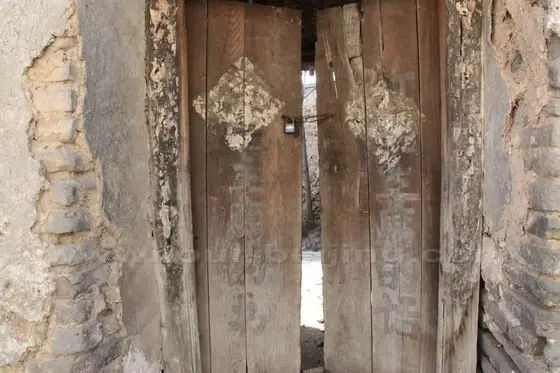 Mao's slogan on the locked door says - Listen to Mao's words and read Mao's book.