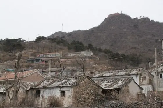 More old and newly built houses sit on the different layers on the hillside.