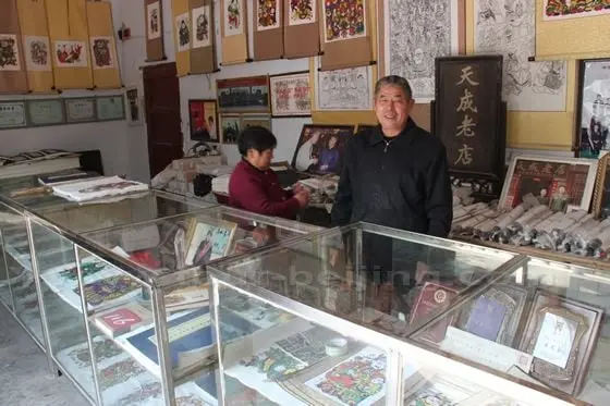 Mr Yin Guoquan smiling behind his counter