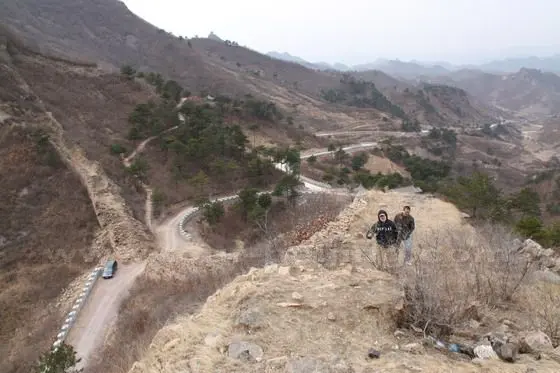 My colleagues, Xiao Hao and Xiao Zhou, follow me up to the east section of Zhuizishan Great Wall.