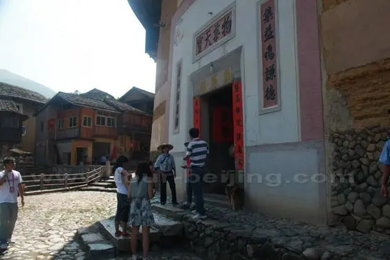 Our village tour guide is introducing Jiqinglou, one of the oldest Hakka earth building at the entrance.