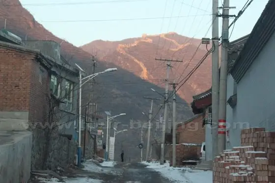 Passing through Dazhenyu Great Wall with a distant view of the Great Wall snaking on the ridges.