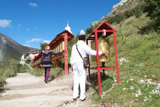 People are turning the prayer wheels clockwise