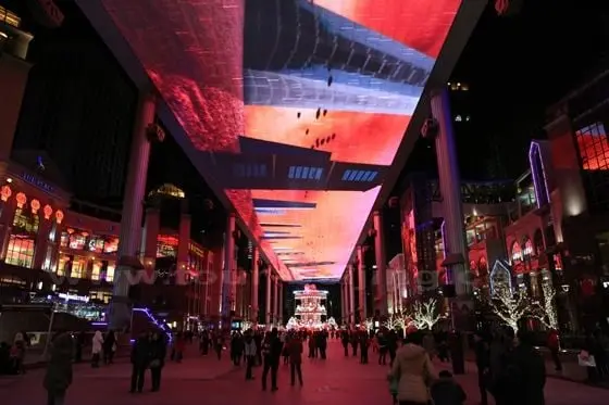 People just stand in awe gaping up a 100 feet above at the football size screen