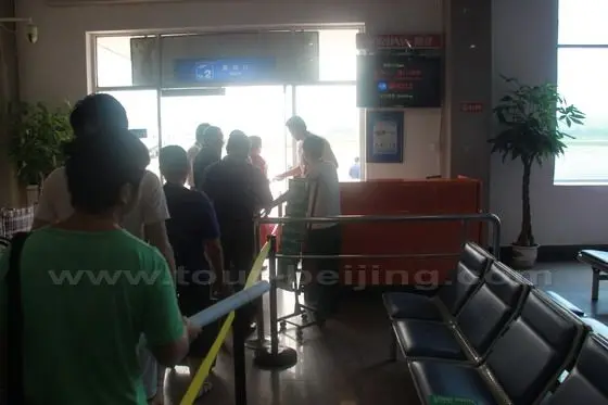 Passengers are going through the final ticket checking and leaving.