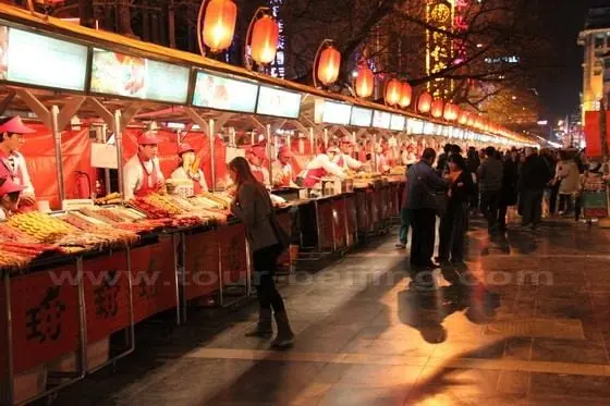 Red lanterns, signboards and clean stalls make a interesting tourist food street in Beijing