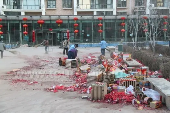 Sanitation workers are sweeping tons of fireworks debris of firecrackers