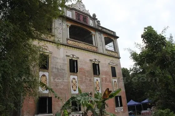 The diaolou tower is harmoniously nestled in the greenery of the village.