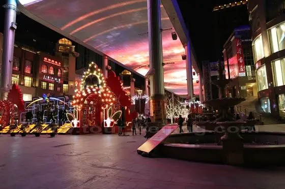 The east-west huge screen is flanked by two luxury buildings