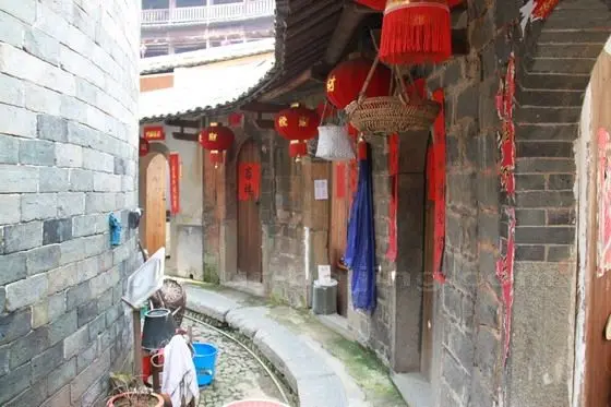 The narrow slab road between Chengqilou's third ring building and the ancestral hall.