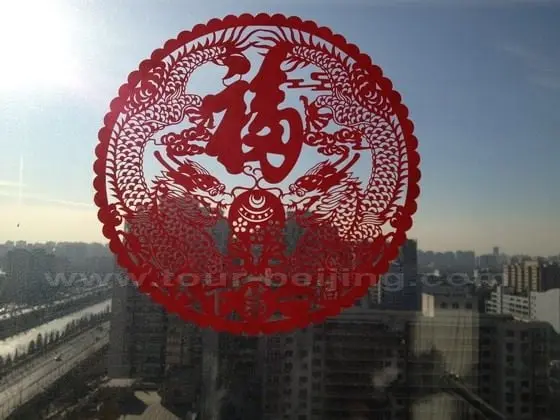 The paper cut is stuck to the window in my office with a backdrop of the surounding area