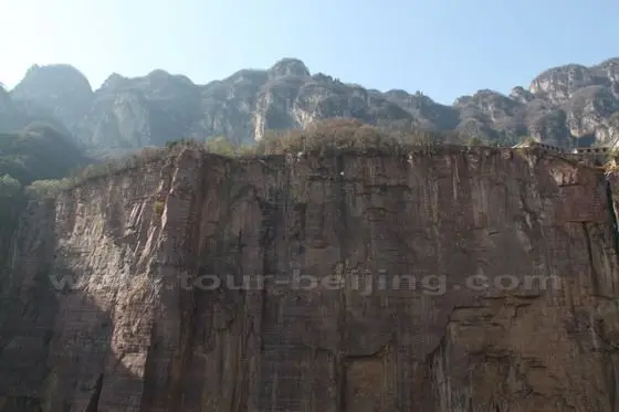 The precipice opposite the cliff with the carved road is upright as if knifed and axed with houses on the top.