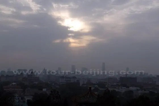 The rising sun finds a hole in the clouds and appears triumphantly