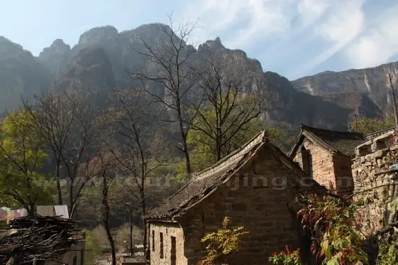 The rooftops and the mountains and the blue sky