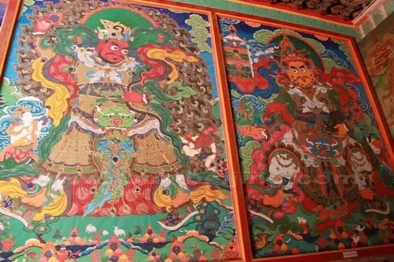 The tangka paitings on the wall by the entrance to the temple.