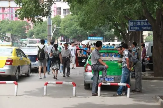 The taxi stand is northwest to the square in front of the main terminal building