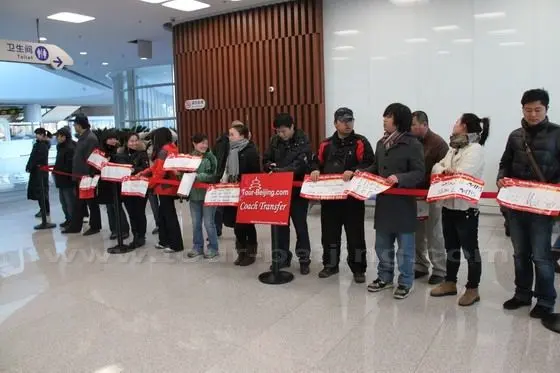 The tour guides from www.tour-beijing.com are waiting at the Exit 03