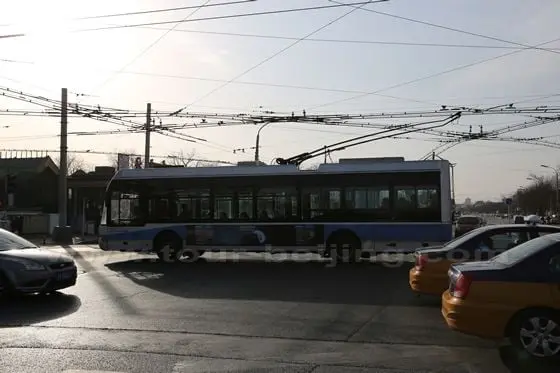 The rolleybus is driving by Dianmen Dajie