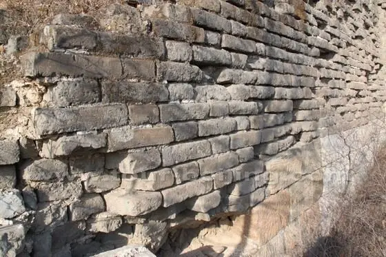 The wall is faced with bricks with dressed slat base.