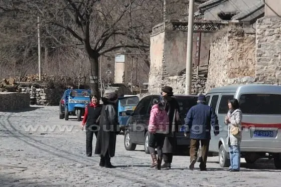 Two foreign visitors have just arrived at the village and guided by Beijing tour guides.