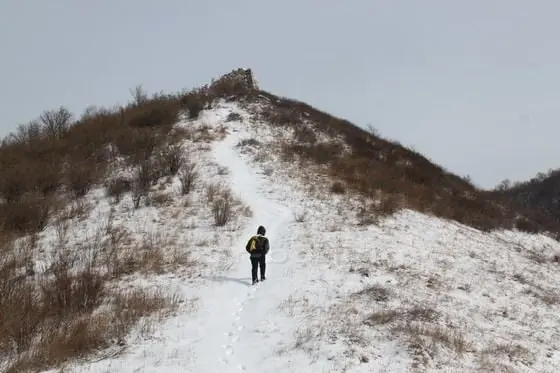 Walk up to the round stone mound on the top