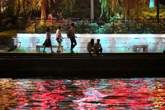 Walking on the illuminated waterway shores