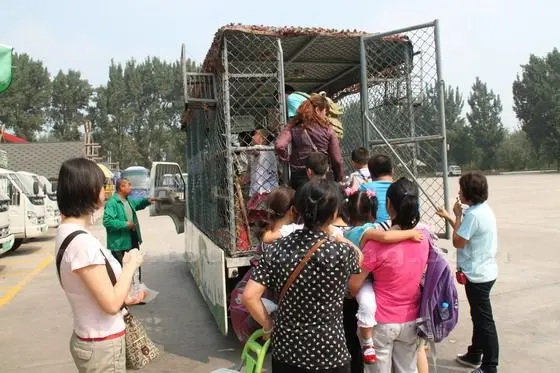 We are boarding a mesh-enclosed truck holding 20 people for 15-minute drive