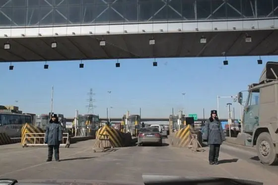 We are passing through the main gate of Tianjin Port, checkpoint to supervise each truck going in and out