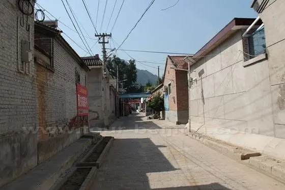 We are walking into the village lined with brick farmhouse courtyards