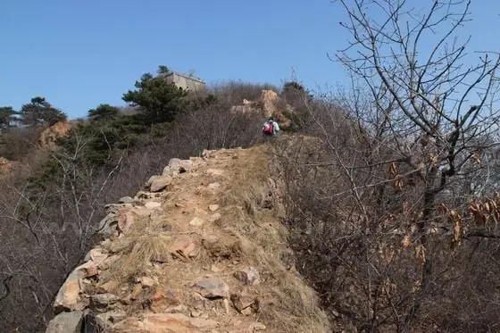 We continue to trudge up on a treacherous wall ridge up to the second watch tower.