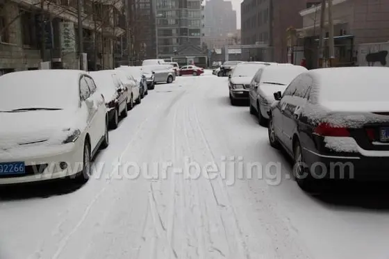 White blanketed cars parking outside our residential area.