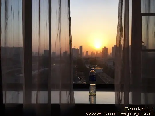 the sunrise glow coming between the hotel window curtains