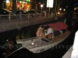 a boat cruising on the Shichahai Lake