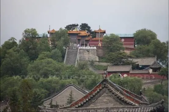 Another temple is nestled on a top cirecled by trees
