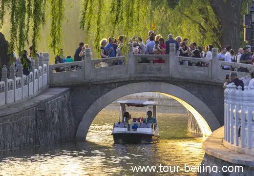 The bridge with weeping willows glowing and shining sunset.