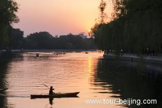 The rippling water of the lake is shined with golden lights